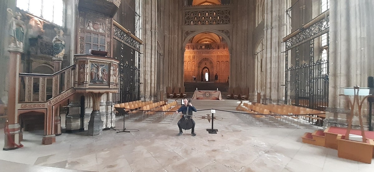 Kenneth playing his cello in a cathedral